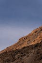 Brown Mountain Slope against Blue Sky