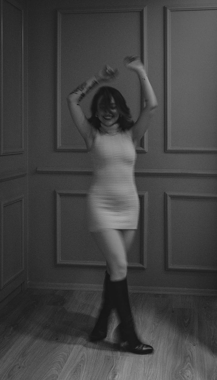 Happy Young Woman In Dress Dancing