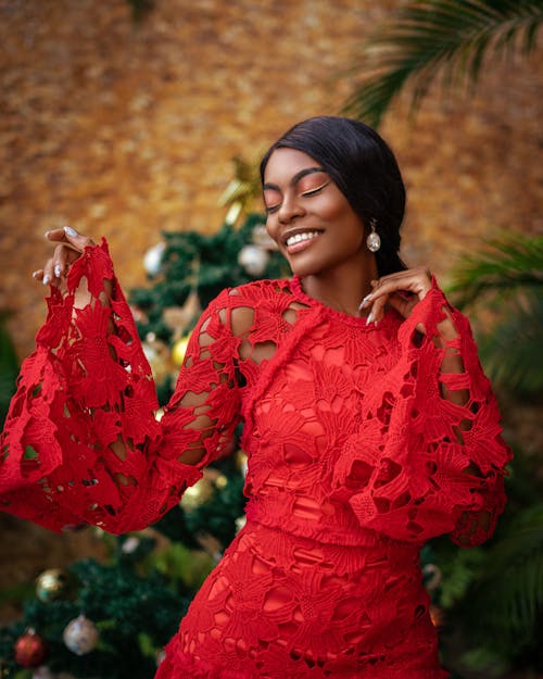 Smiling Model in a Red Openwork Dress