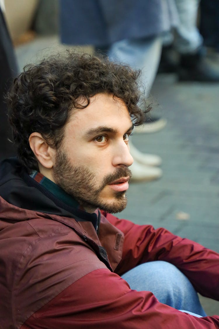 A Man Sitting Outdoors