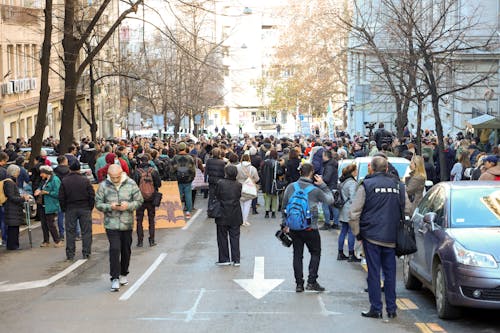 Crowd of People Standing on a Street