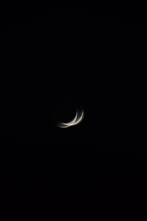 Blurred Crescent Moon in Night Sky