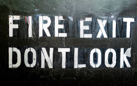 Painted display lettering on a weathered dark wall — photo by David McElwee on Pexels