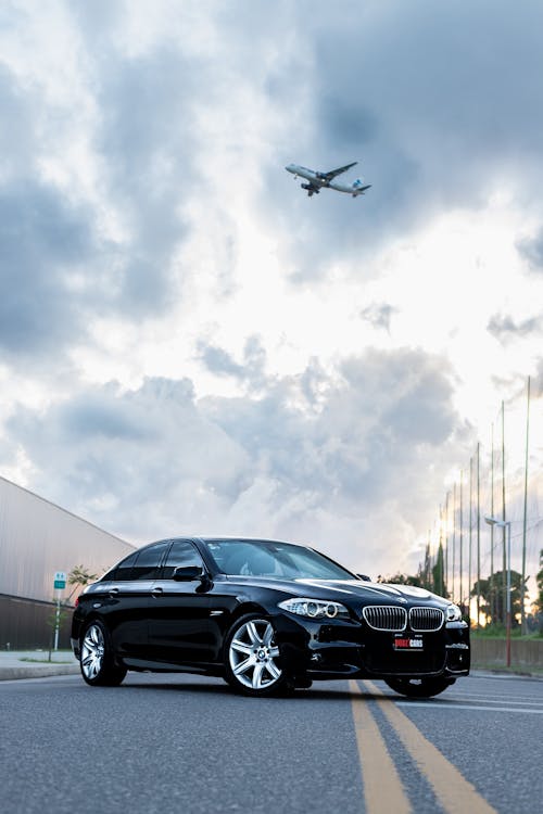 Black BMW 5 Series F10 on a Street by the Airport