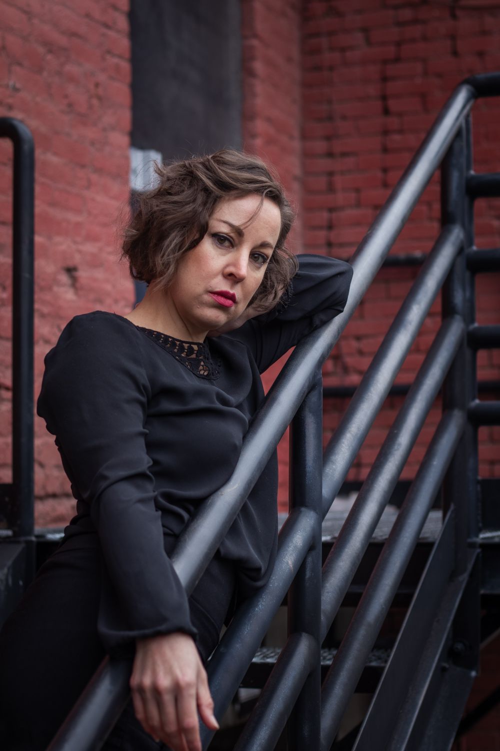 Leaning Back Against Railing Woman Standing on the Steps and Leaning against the Railing · Free ...