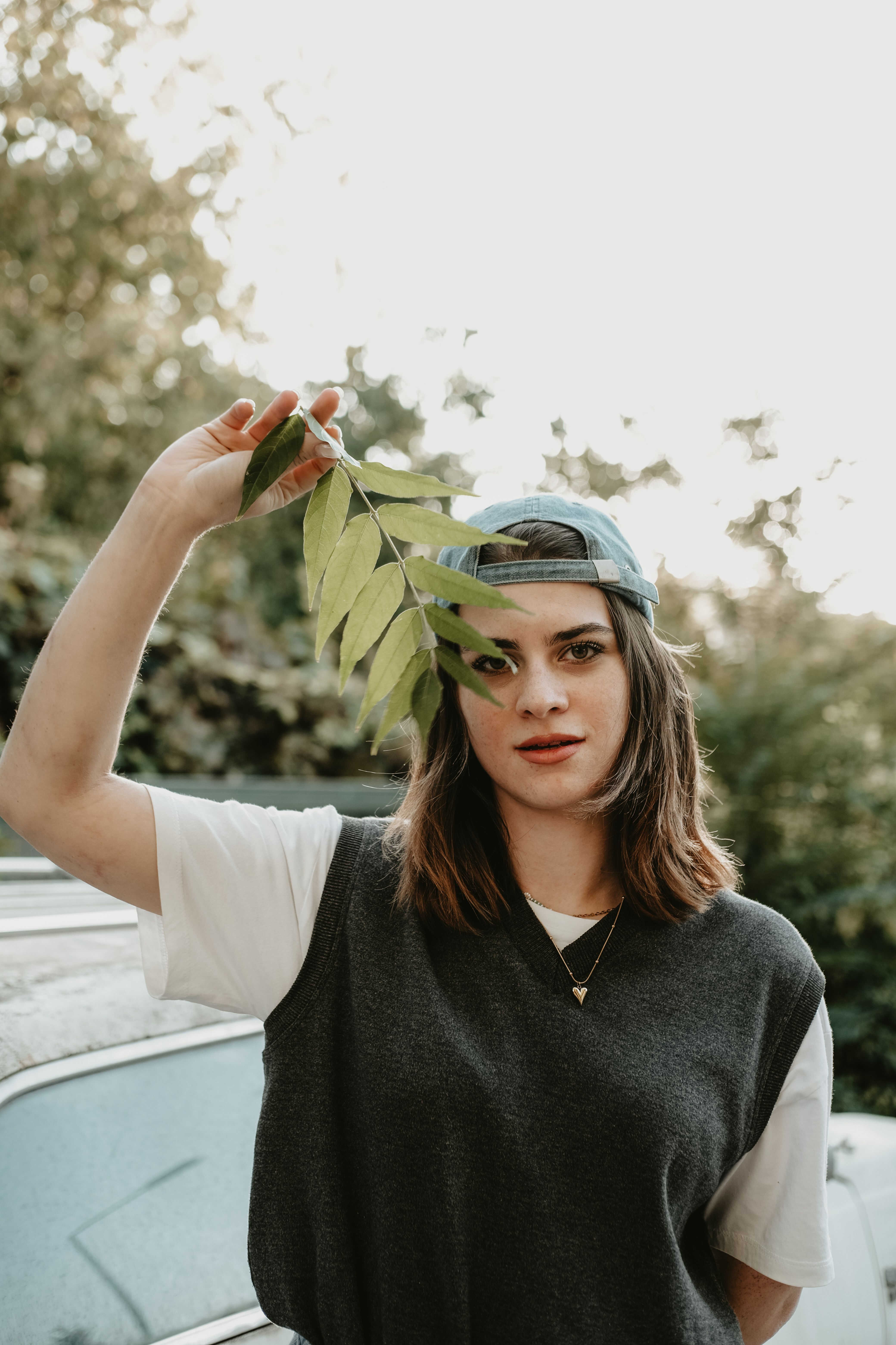 Brunette Woman Posing in Front of a Car · Free Stock Photo