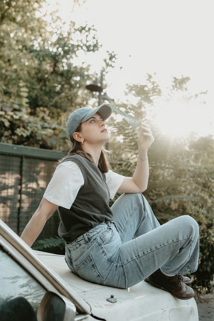 Girl Wearing Jeans And A Baseball Cap 