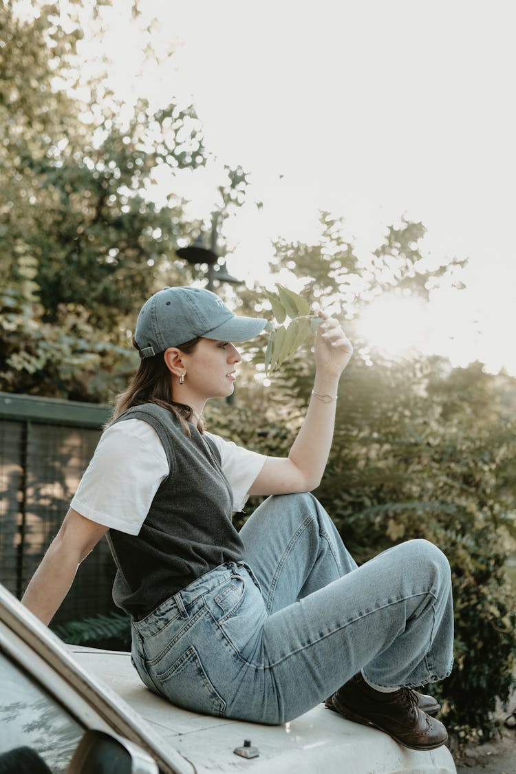 Girl Sitting On The Hood Of A Car 