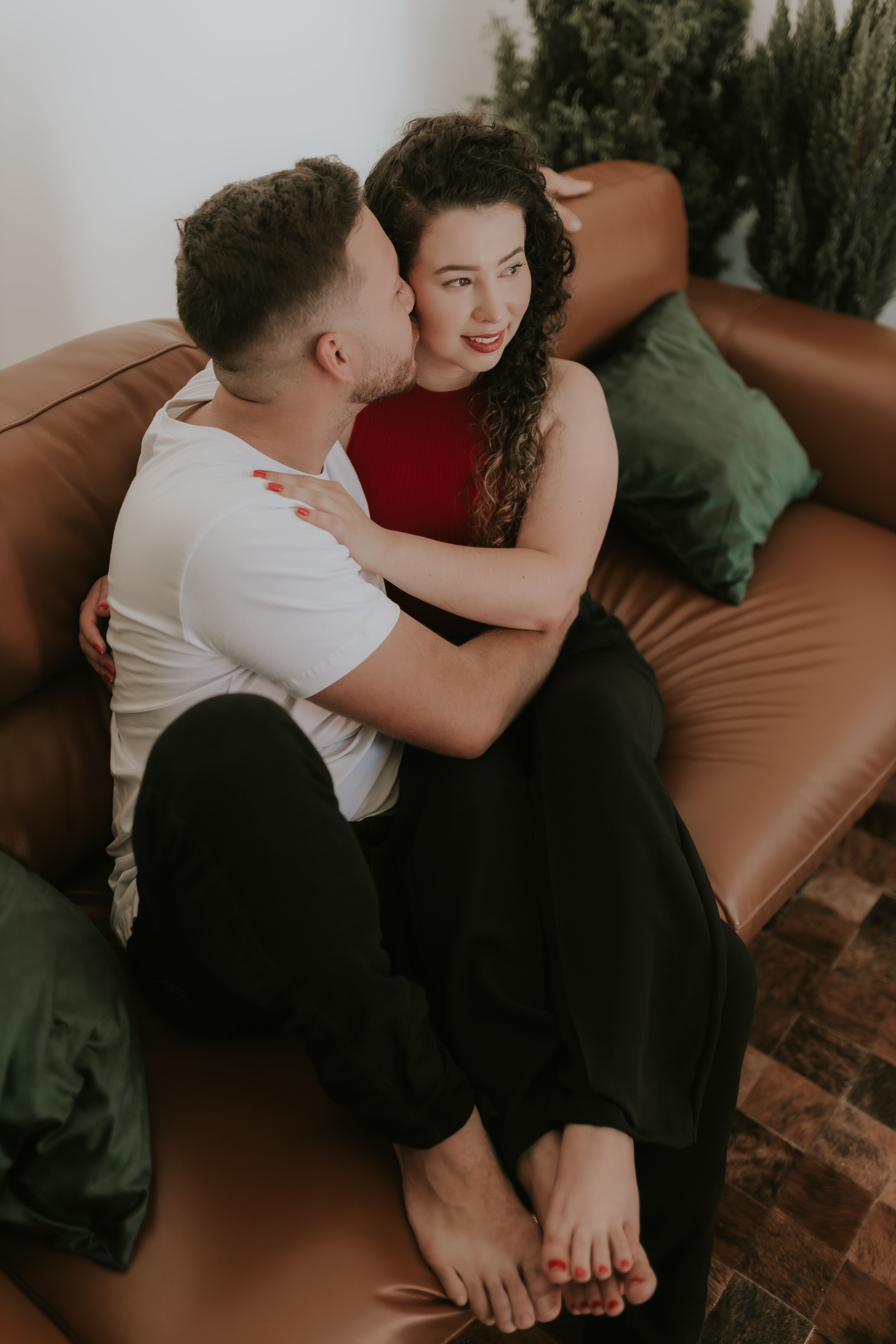 Couple Cuddle on Sofa · Free Stock Photo