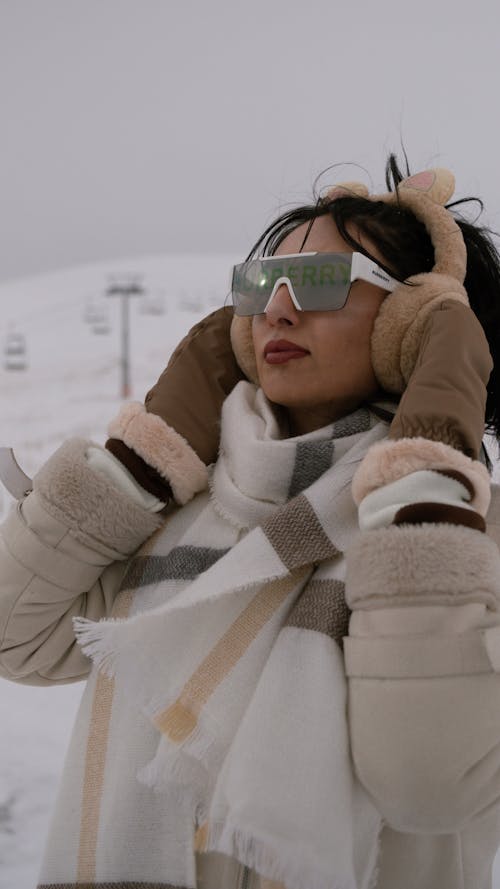 Young Woman in a Fashionable Winter Outfit and Sunglasses