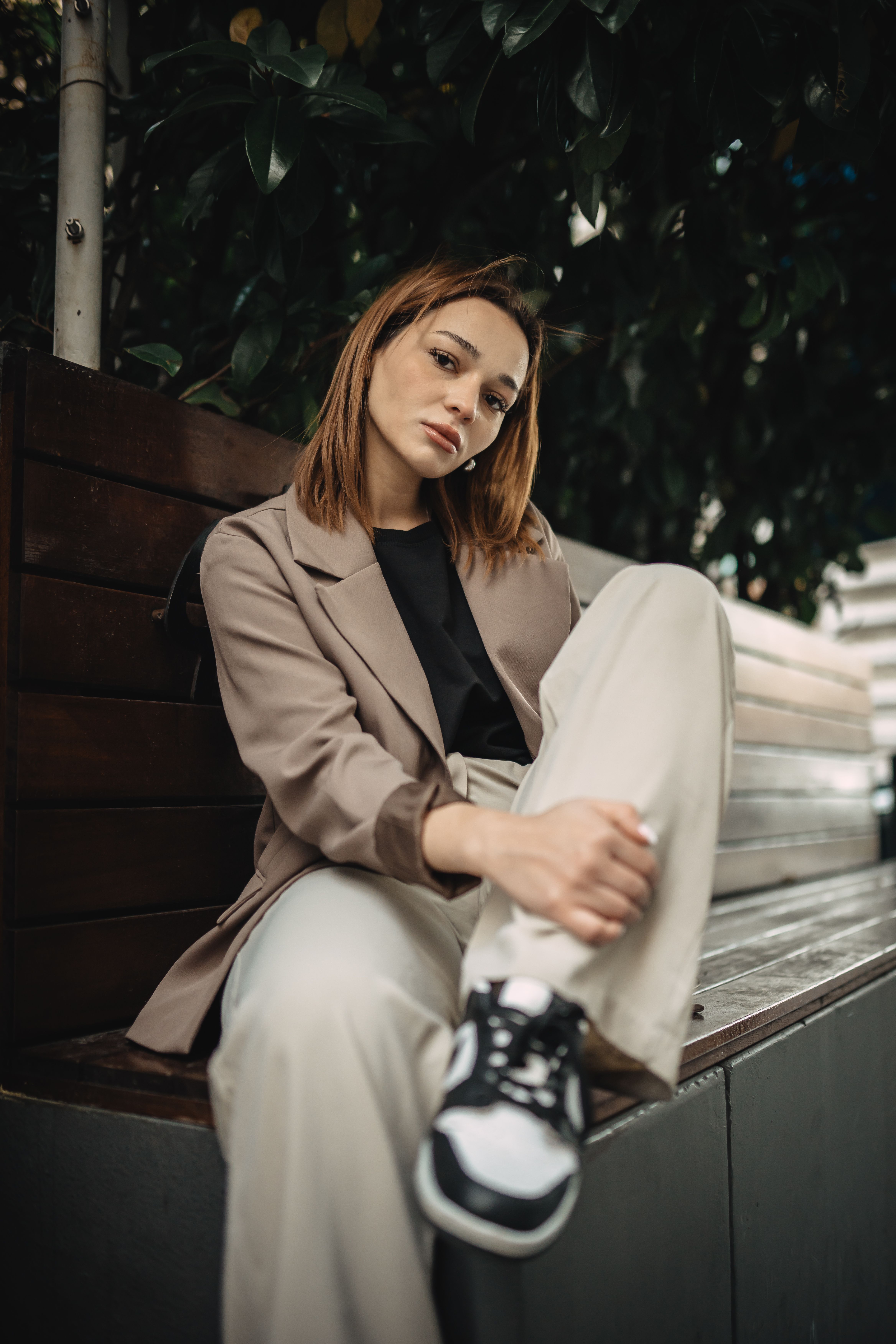 Model in a Light Brown Blazer and Gray Pants Sitting on a Bench · Free ...