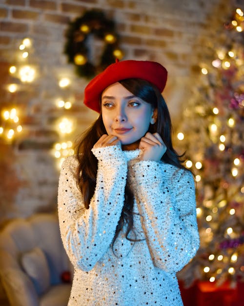 Model in a White Dress and a Red Beret in a Christmas Decorated Living Room