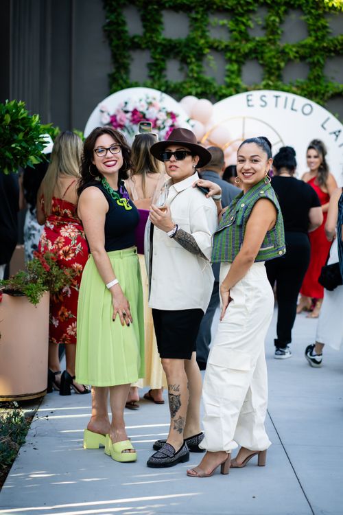 Free A stylish group of friends enjoying a summer event outdoors, showcasing vibrant fashion and smiles. Stock Photo