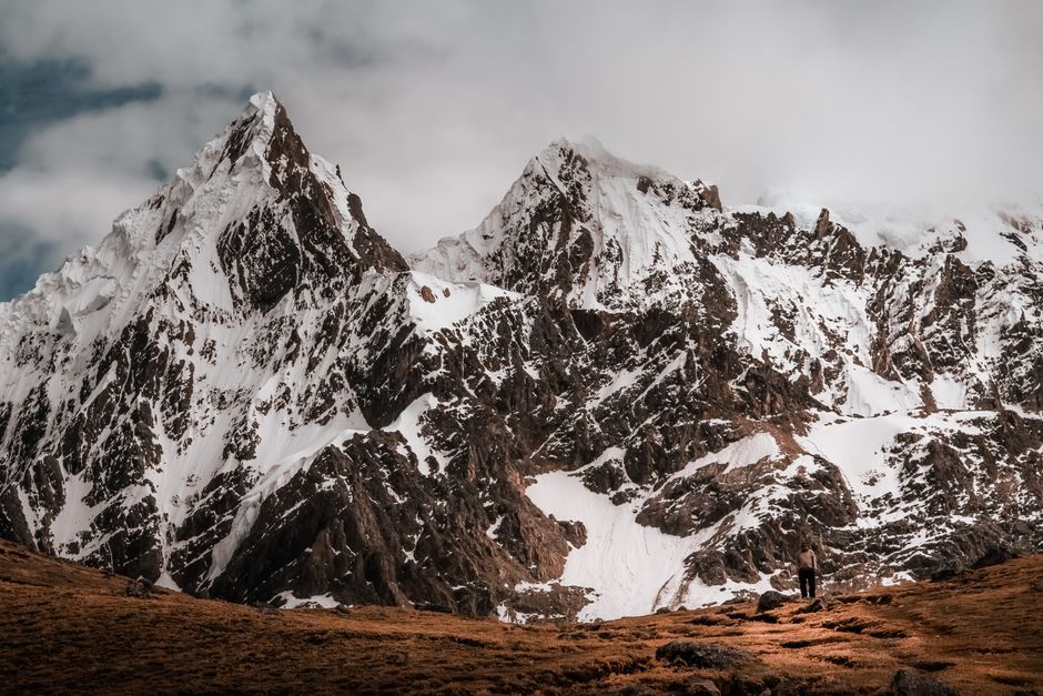 Unbeatable Huaraz: Pastoruri Glacier - Day Tour - Ice and Adventure Review 2026 - Rugged and snow-covered peaks of the Andes Mountains in Cusco, Perú, with a lone traveler admiring the vastness.