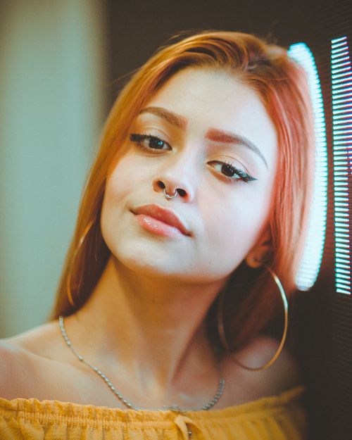 Free Close-up portrait of a confident woman with a nose ring and striking makeup. Stock Photo