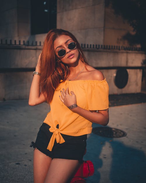Free Woman Wearing Yellow Off-shoulder Blouse and Black Shorts Stock Photo