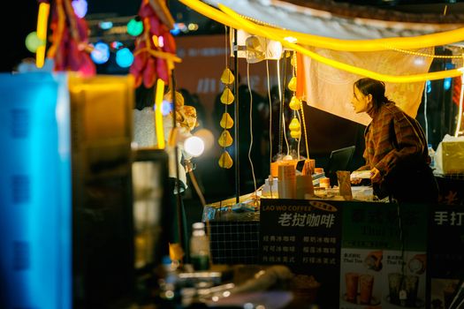 Night market textiles with a weaver — Luang Prabang