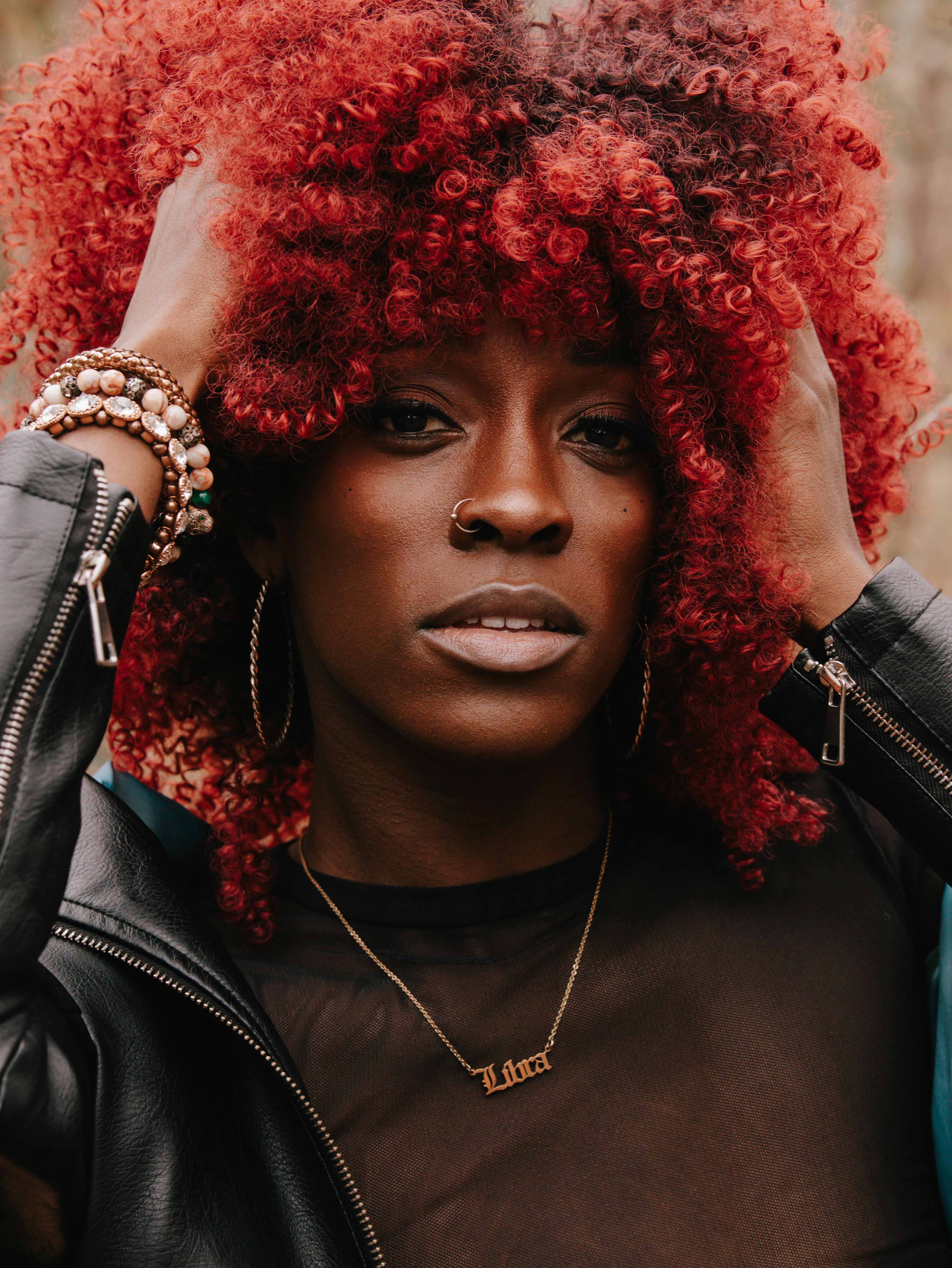 portrait of a black woman with red curly hair