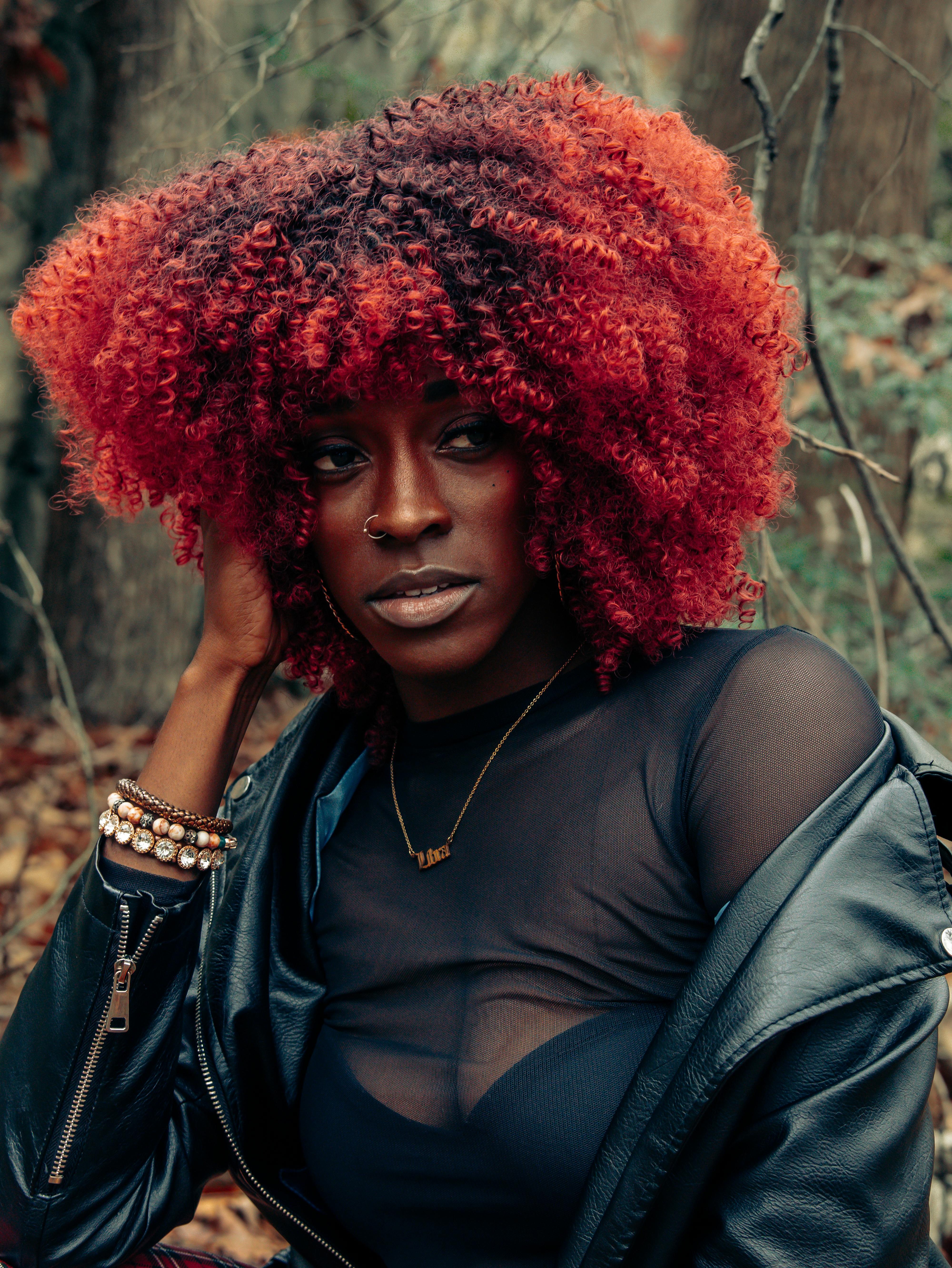 a black woman with red curly hair