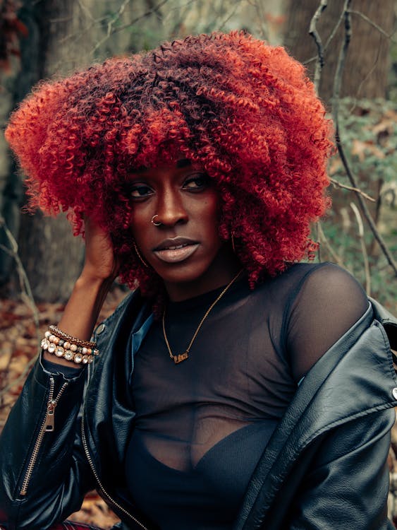 a black woman with red curly hair 