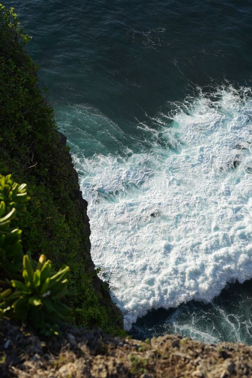 Free Aerial view of stunning cliffs and crashing waves in Bali, Indonesia. Stock Photo