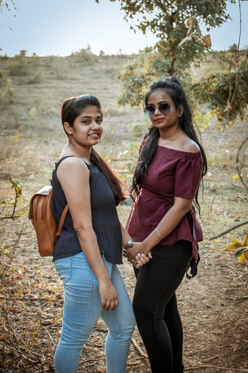Two Young Women Posing for a Photo in the Wilderness 