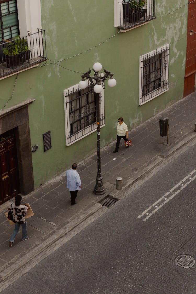 High Angle Shot Of People Walking The Street