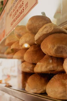 Close-up of freshly baked bread rolls in a bakery display in Puebla, Mexico.
