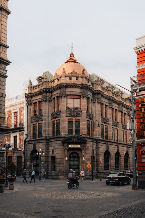 Free Street view of historic architecture at a busy corner in Puebla, Mexico. Stock Photo