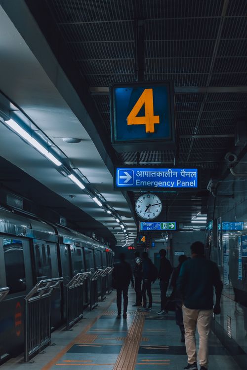 Free People commuting at a dimly lit subway station platform in India, highlighting urban travel. Stock Photo