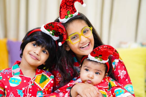 Smiling Siblings at Christmas