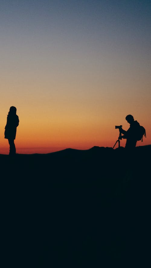 Photographer and Model Silhouettes at Dawn