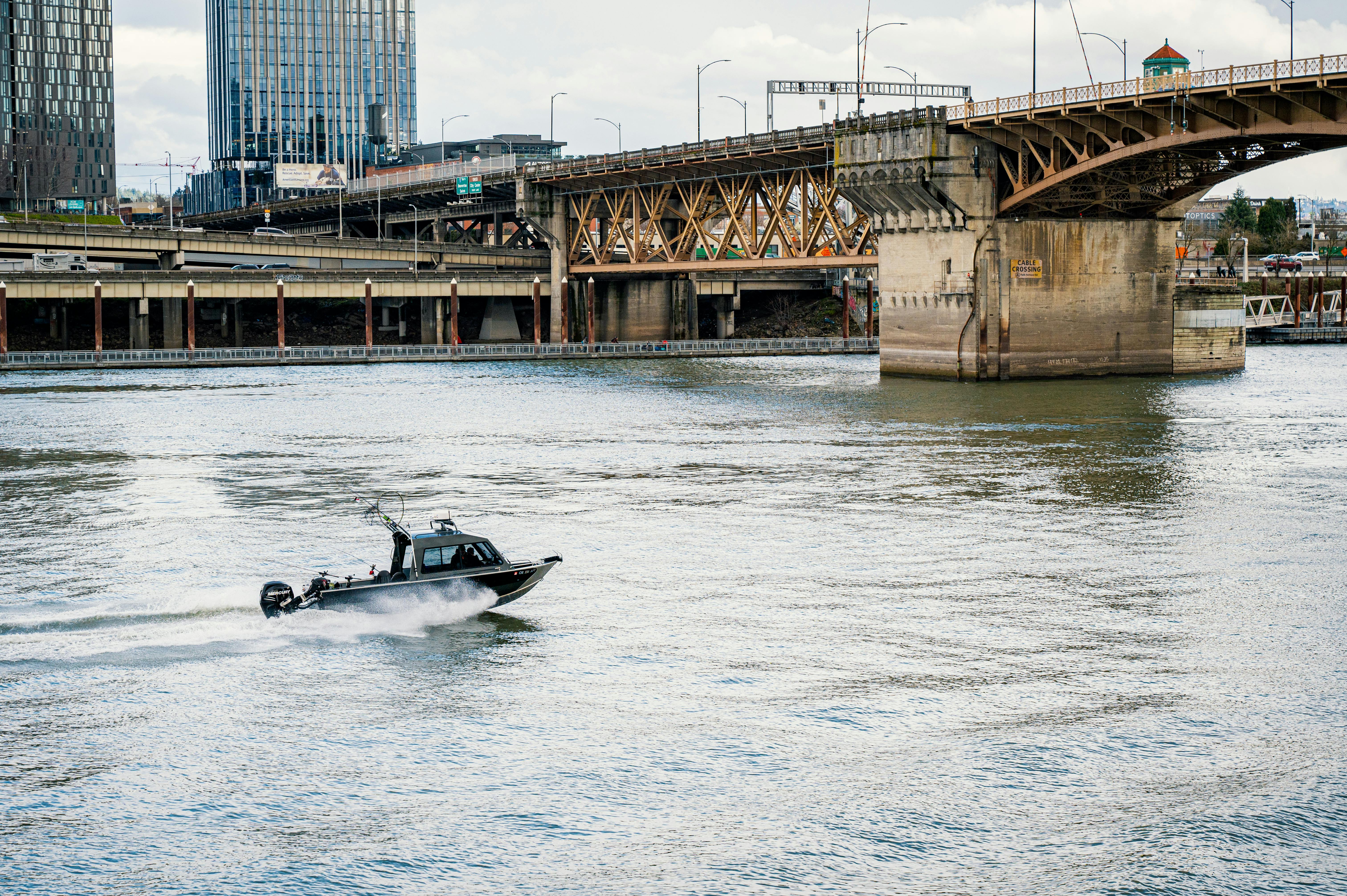 Cyclists on Portland's Hawthorne Bridge with downtown skyline - apartments near Portland Oregon
