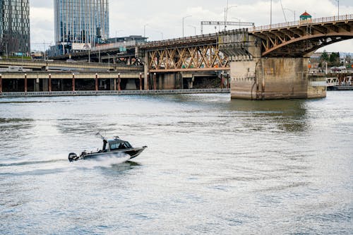 Motorboat on River near Bridge