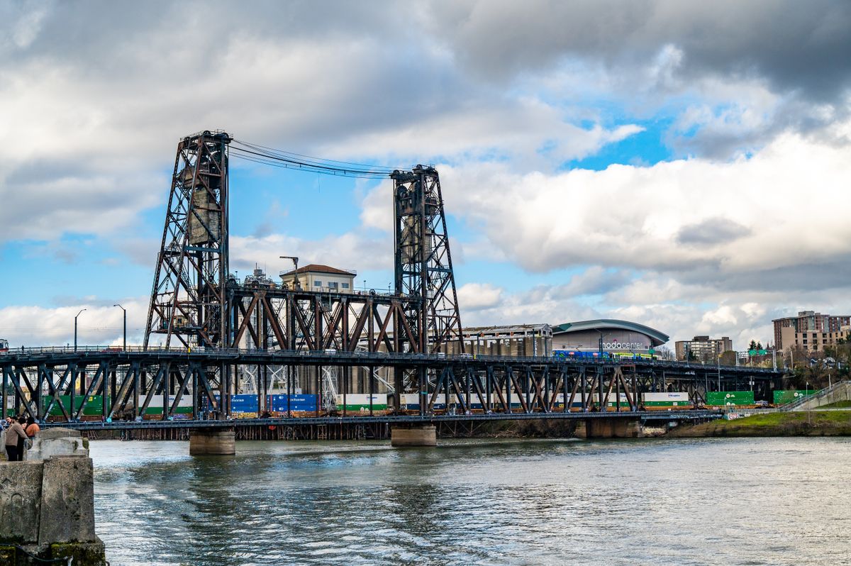 Portland's Steel Bridge spanning the Willamette River under a soft overcast sky