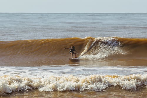 Boy Surfing on Sea Shore