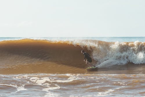 Man Surfing on Sea Shore