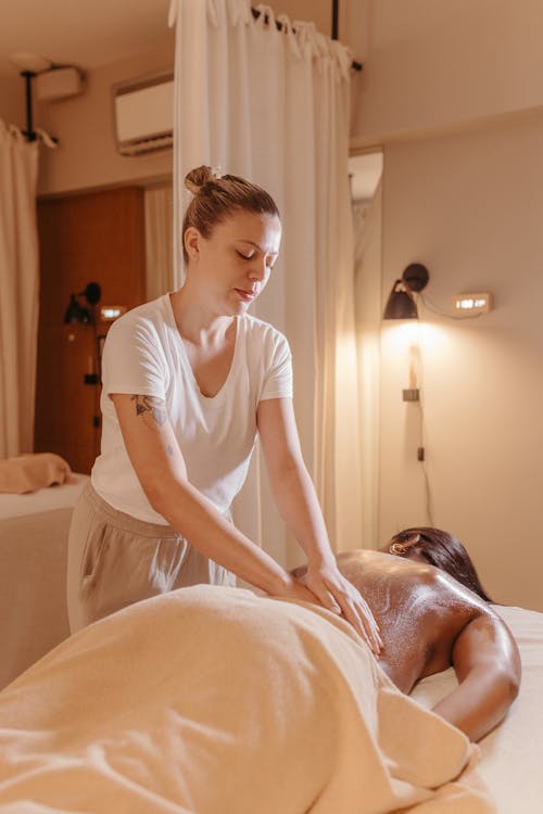 Massage Therapist Giving a Massage to a Woman 
