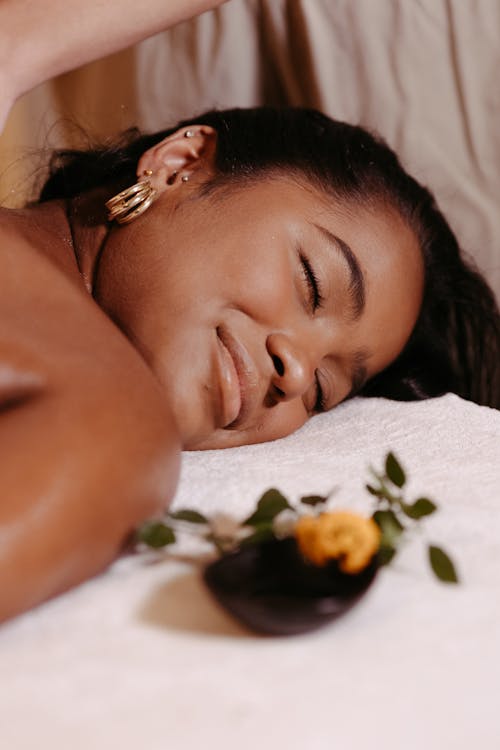 Woman Lying on a Massage Table and Smiling