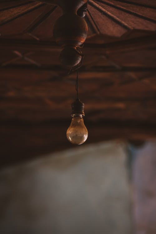 Old Light Bulb Hanging Under Ceiling