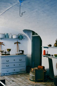 Rustic kitchen interior showcasing vintage utensils and decor in a warm, nostalgic setting.