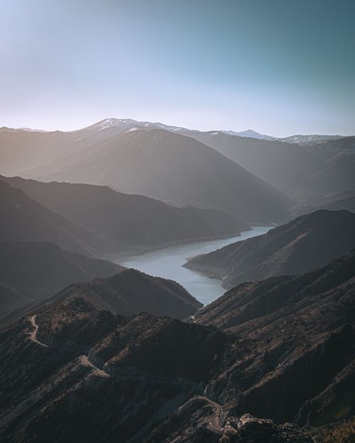 Free Captivating vista of Kozjak river winding through misty hills at sunrise in North Macedonia. Stock Photo
