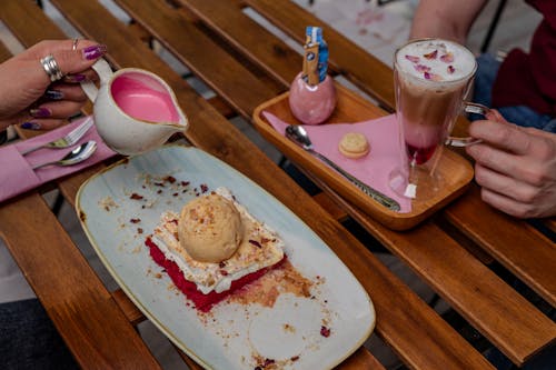 People Sitting at Table with Desserts