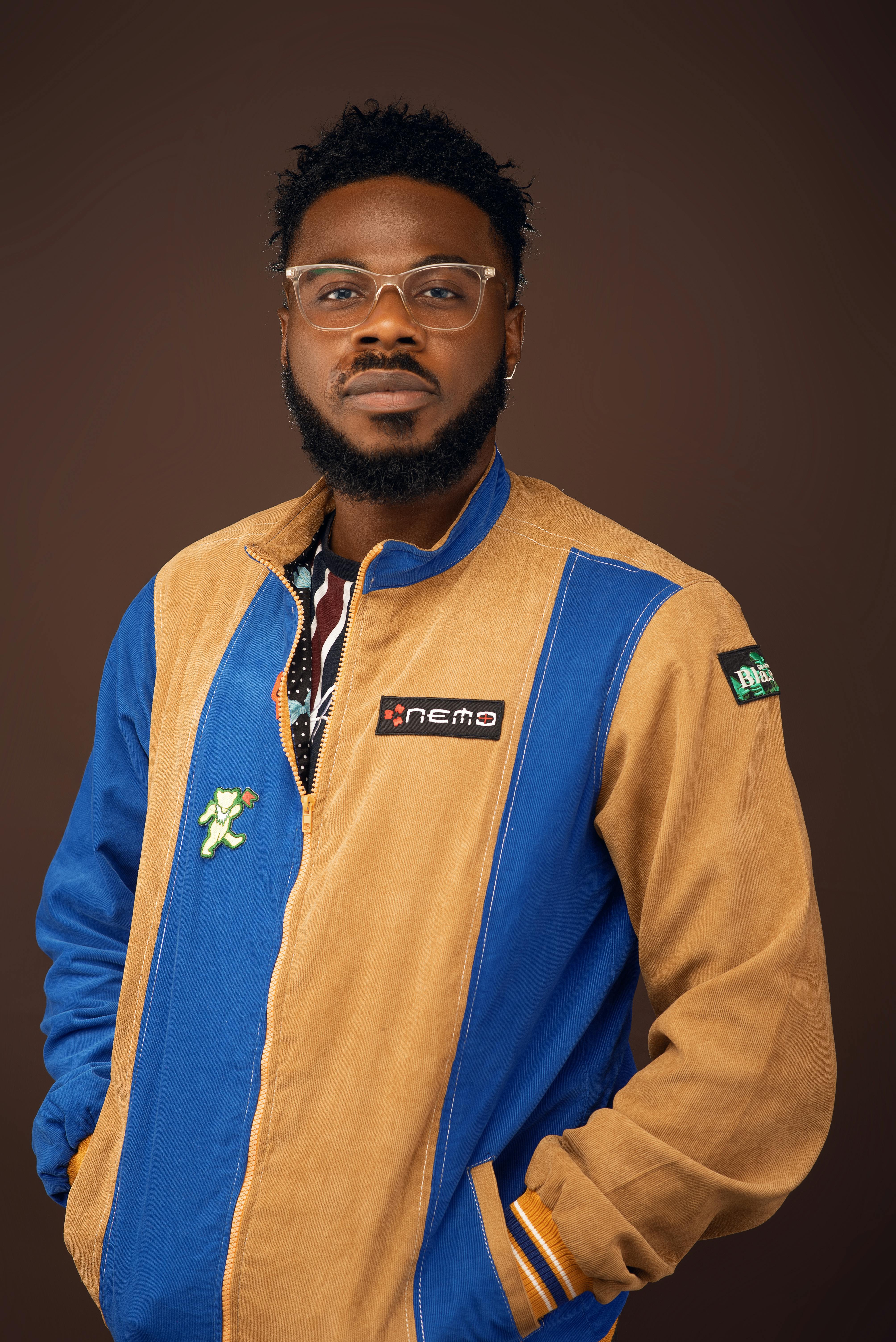 A man in a blue jacket and brown pants · Free Stock Photo