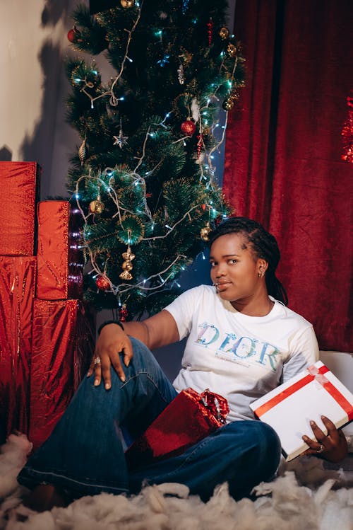 Woman in White T-Shirt Sitting with Presents on Lap