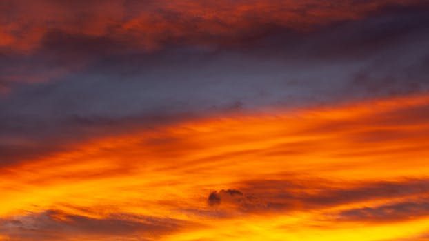 Stunning sunset sky with vibrant orange and purple hues captured in Bombinhas, Brazil.