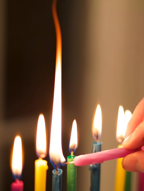 Free A person is lighting candles on a hanukkah menorah Stock Photo