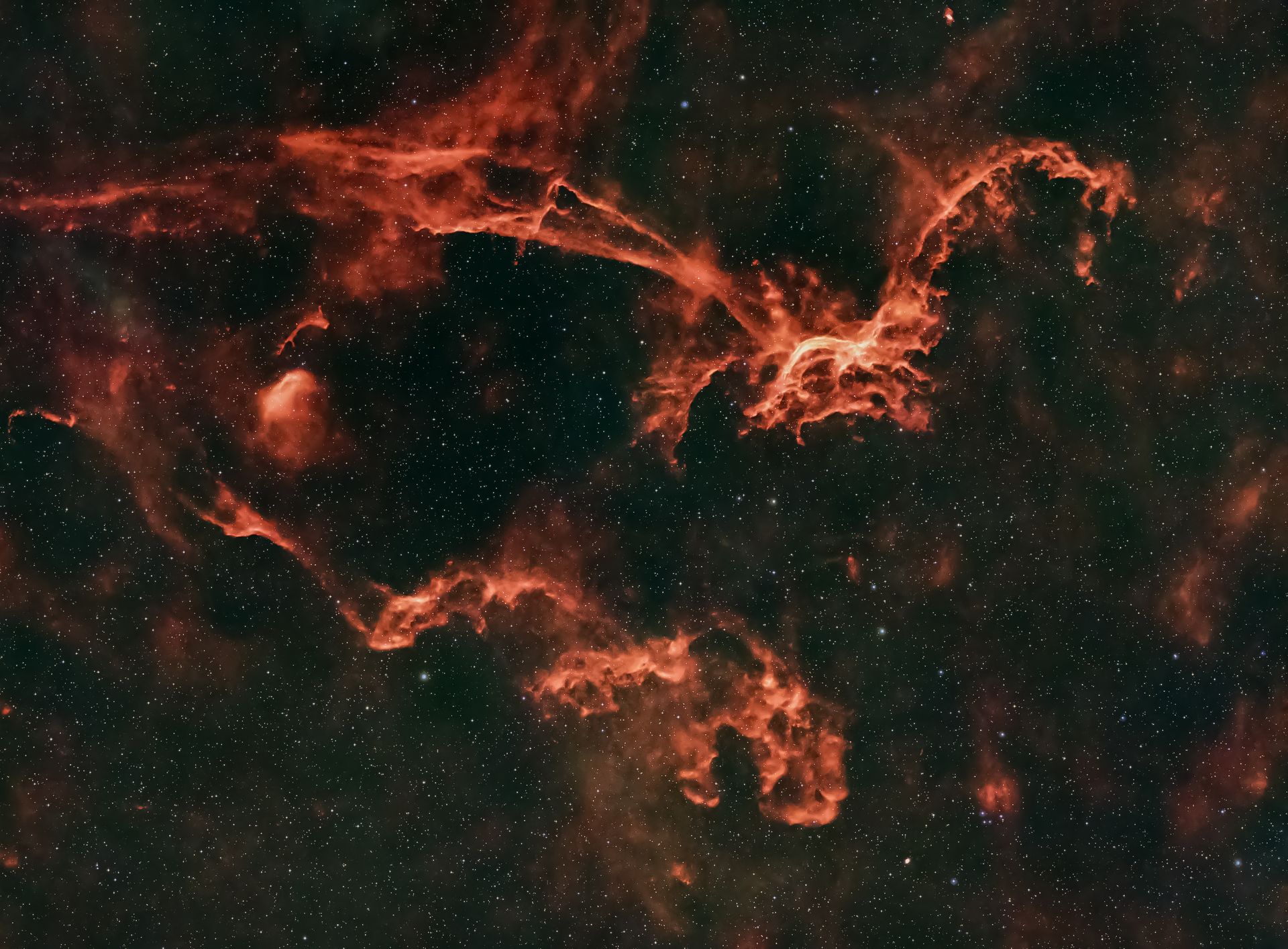 A vibrant red nebula surrounded by stars, highlighting the infinite cosmos.