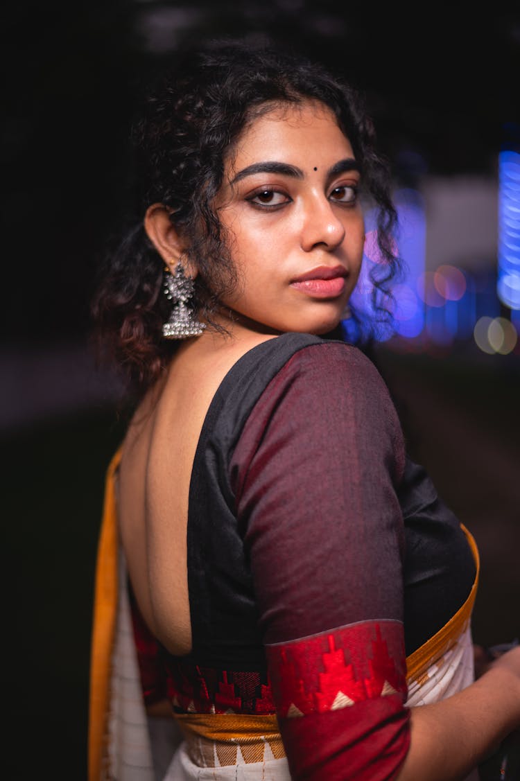 Brunette Woman In Colored Sari Looking Over Shoulder