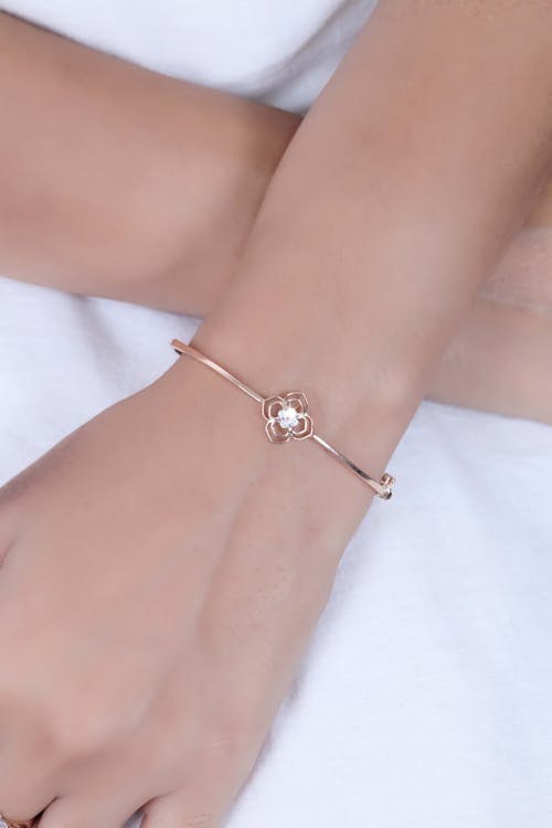 Close-up of Woman Wearing a Delicate Bracelet with a Flower Shape in the Middle 